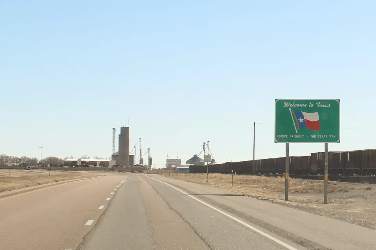 Letrero de bienvenida a Texas en una carretera, el momento en que un carro de otro estado necesita placa registrada